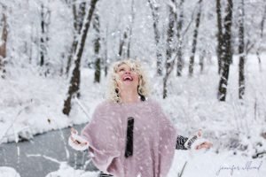 woman throwing snow up in the air