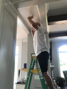 man finishing the ceiling after construction