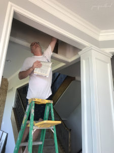 man refinishing the ceiling 