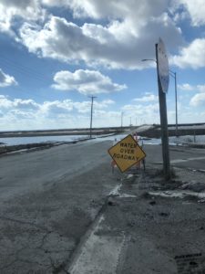 Flooding in Iowa with Caution Sign