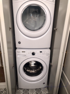 Stackable washer and dryer area in basement bathroom