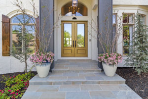close up view of bluestone paver front steps and gold front door