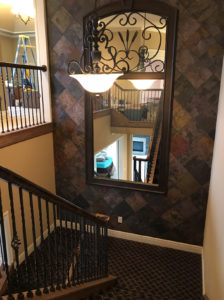 slate wall with big mirror on stair area