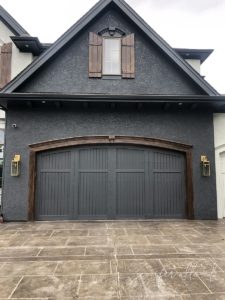dark grey garage with faux wood trim and faux wood shutters around window
