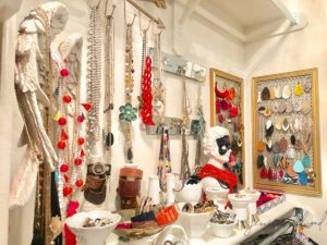 lots of colorful jewelry displayed and organized in closet shelf