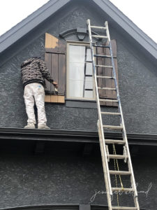 shutters being painted by contractor